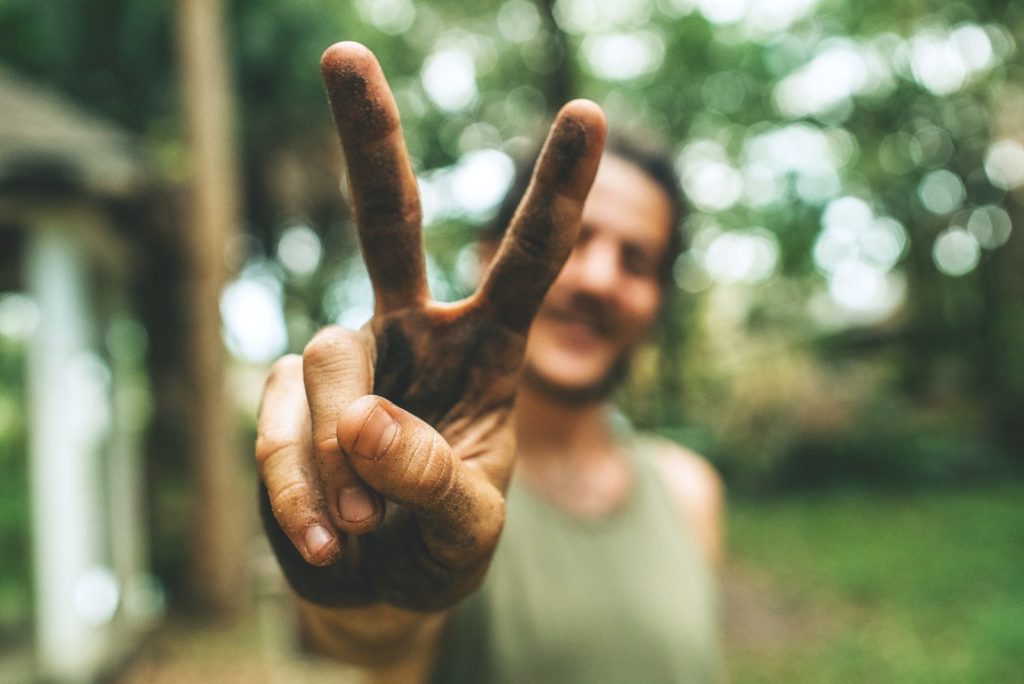 Image of a man giving the peace sign